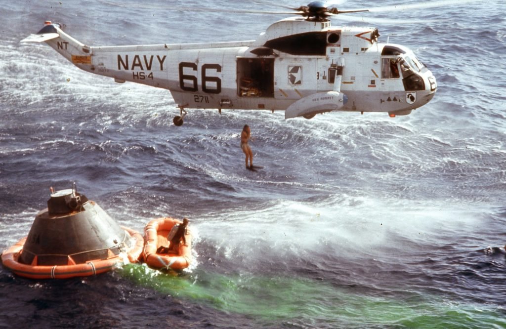 Swimmers diving into the water to secure the Apollo 11 Command Module. Naval Helicopter Association Historical Society