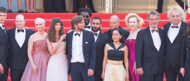 Dolly de Leon with the cast and director of Triangle of Sadness at the Cannes premiere