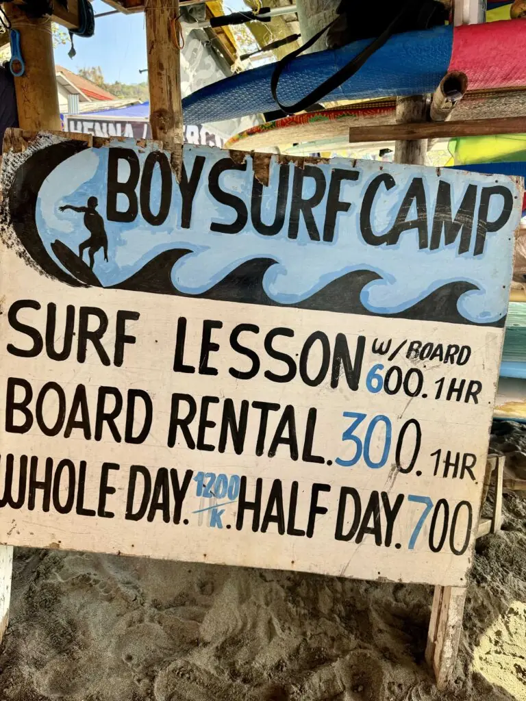 Boy Surf Camp and their signboard for surfing board rental rates.