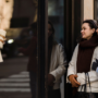 Two women enjoying window shopping in a stylish urban area, reflecting joy and friendship.